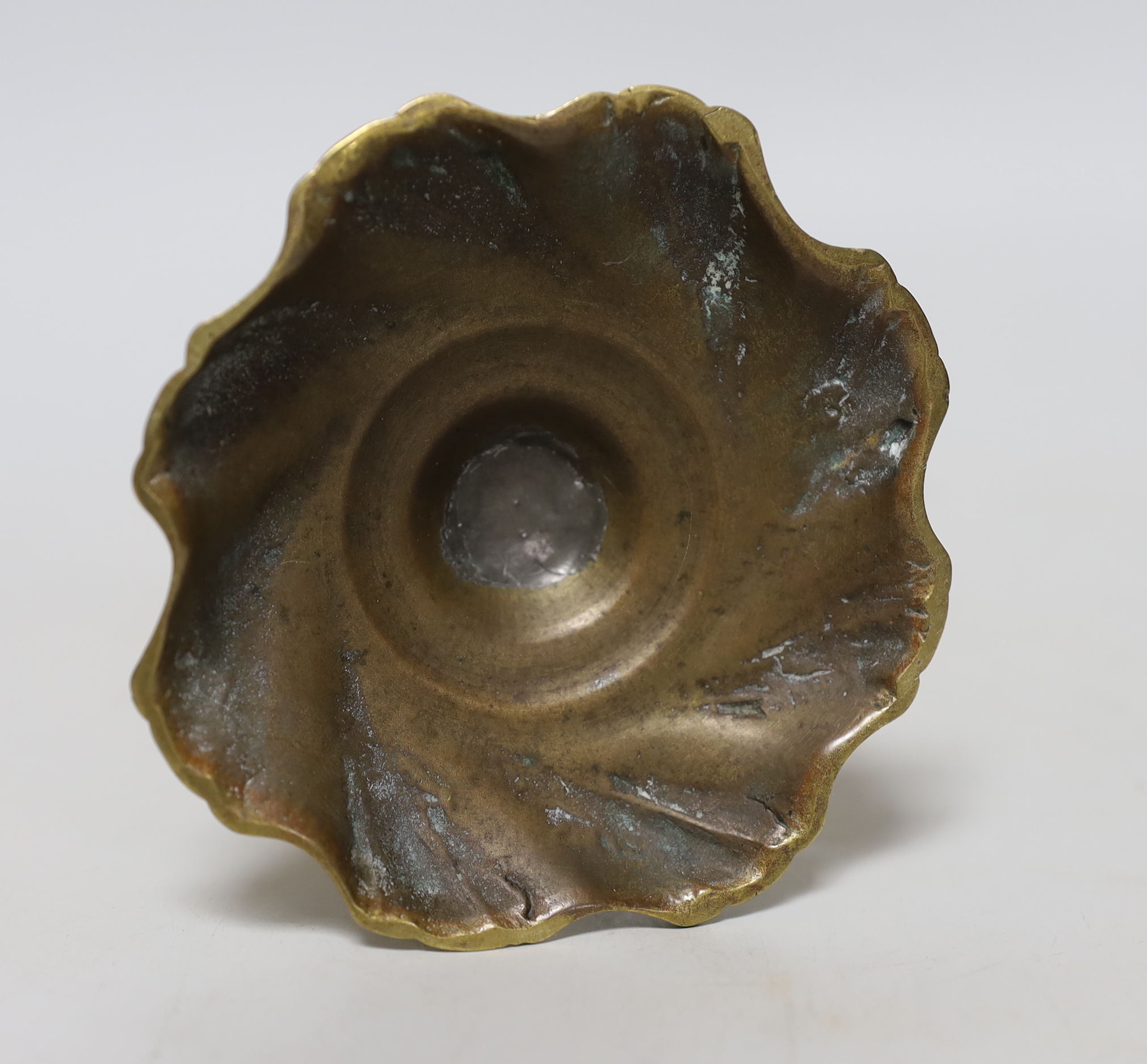 A mid 18th century swirl base brass candlestick, 21cm